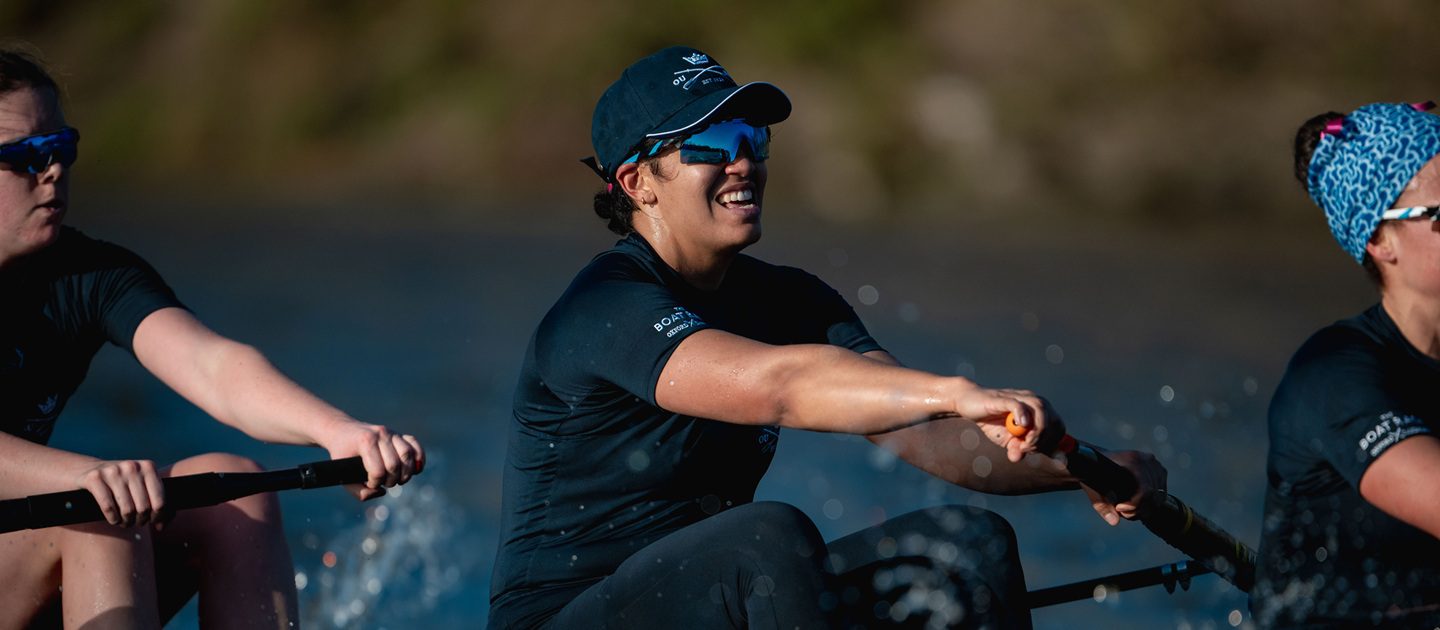 Woman in dark blue Oxford kit racing