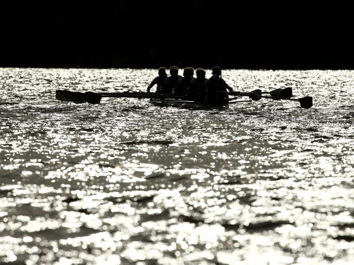 Eight athletes in a boat take to the water for training